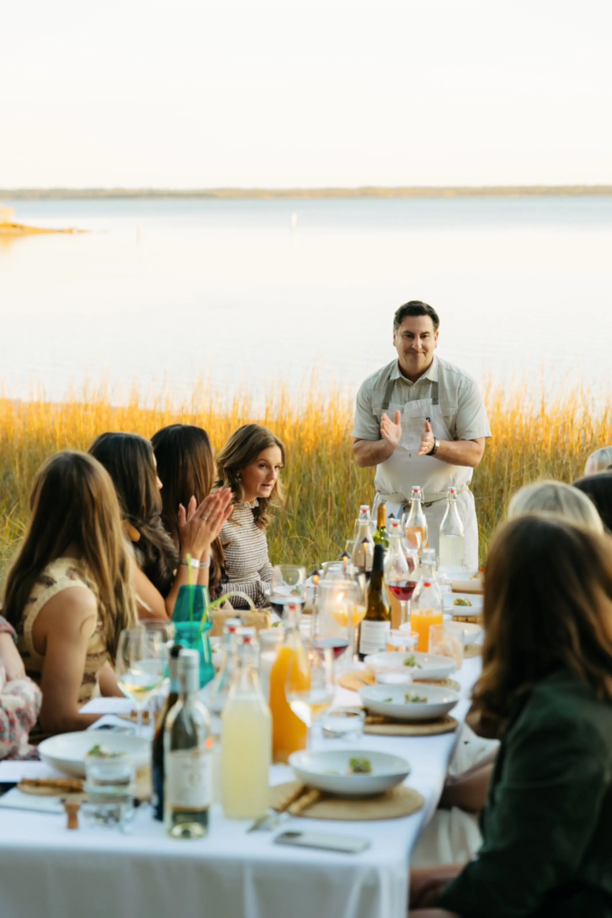 The chef speaking to the table before dinner.