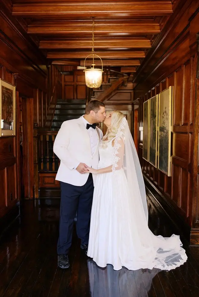 A couple in the cypress stair hall.