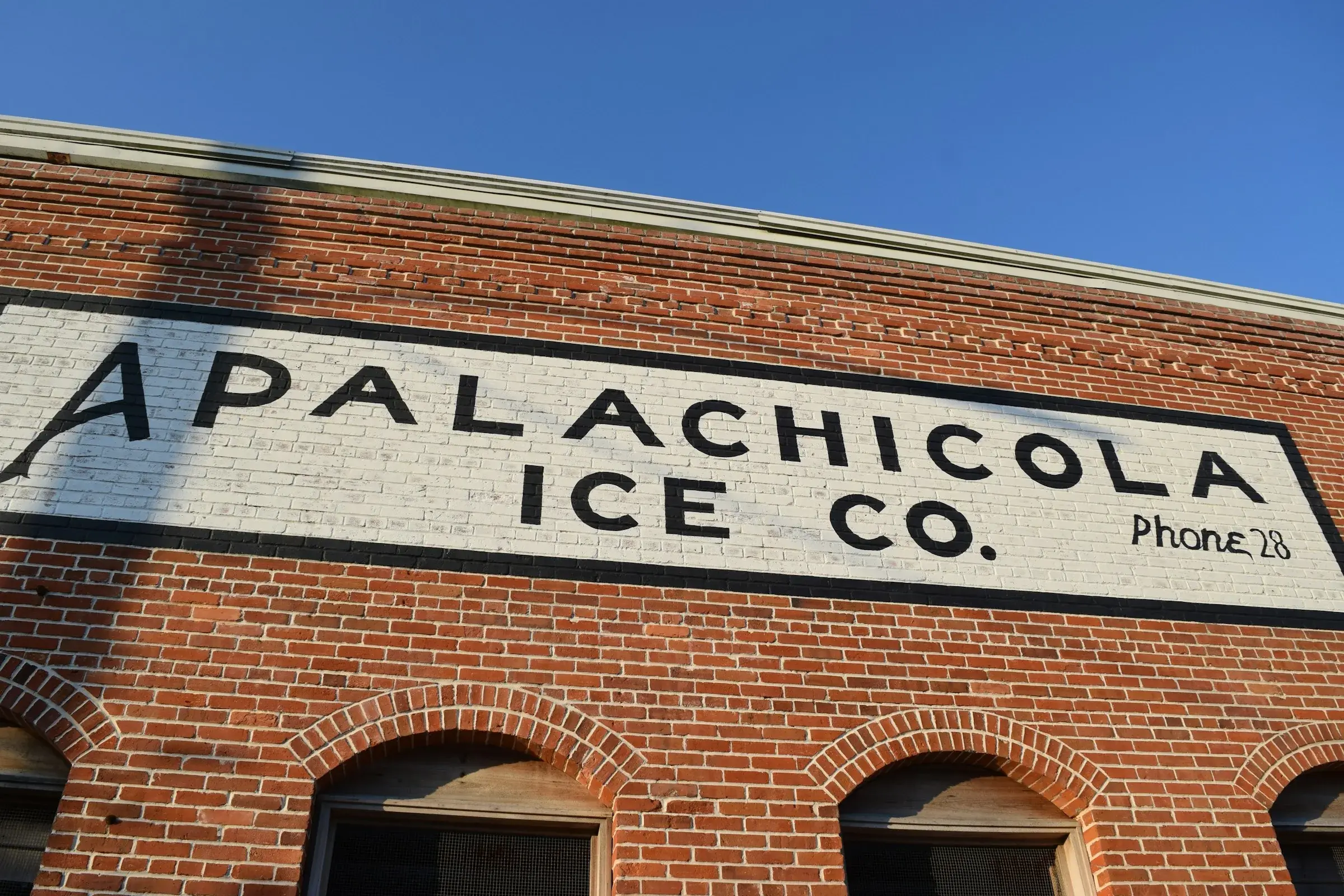 The Apalachicola Ice Company, its hand-painted sign still on the brick.