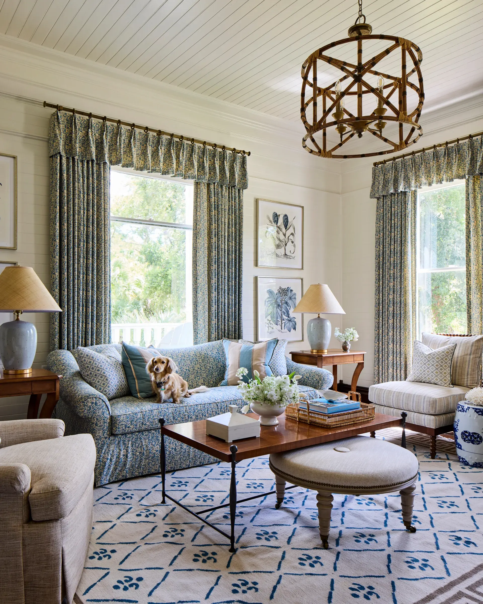 The blue sitting room, two tall curtained windows and a bamboo lantern.